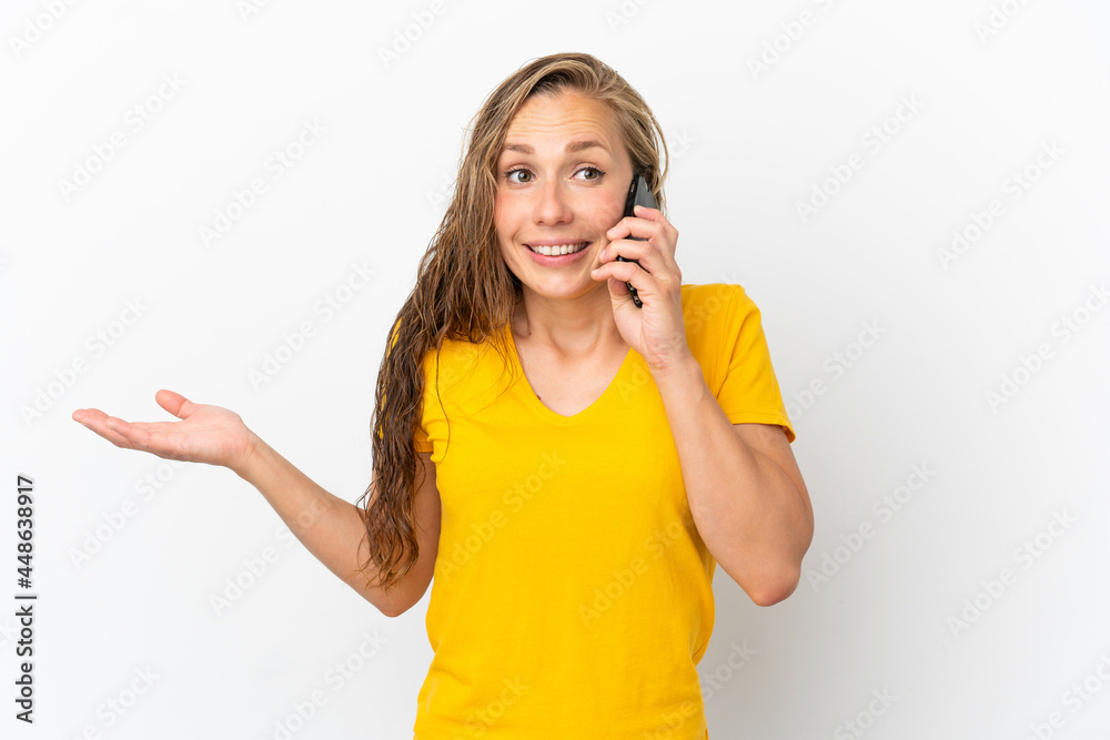 Young caucasian woman isolated on white background keeping a conversation with the mobile phone with someone Young caucasian woman isolated on white background keeping a conversation with the mobile phone with someone
