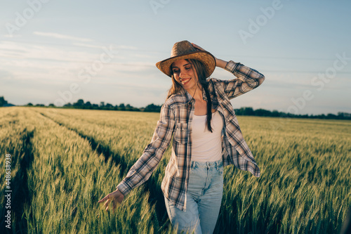 woman farmer walking through wheat field