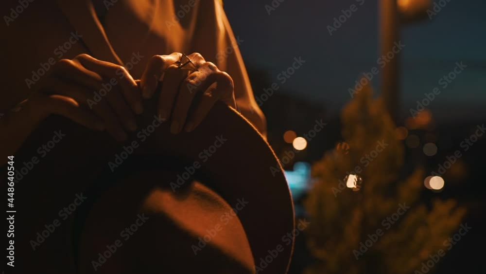 girl holding a retro hat in the evening light