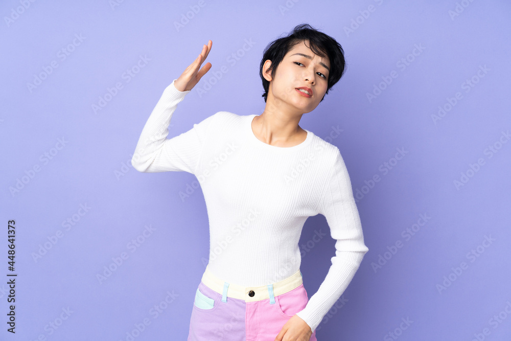 Young Vietnamese woman with short hair over isolated purple background with tired and sick expression Young Vietnamese woman with short hair over isolated purple background with tired and sick expression