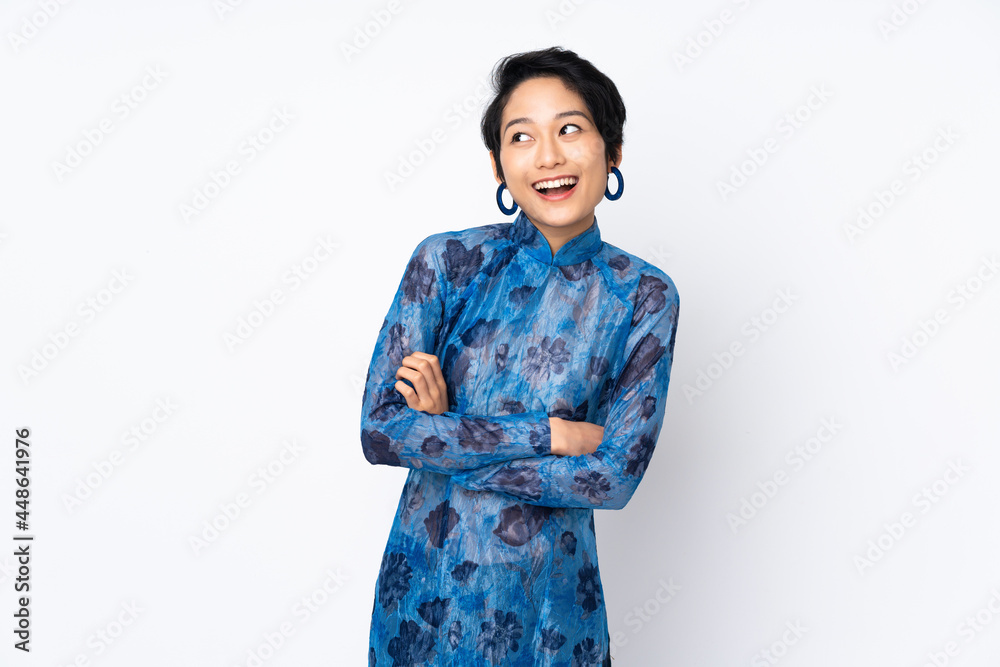 Young Vietnamese woman with short hair wearing a traditional dress over isolated white background happy and smiling Young Vietnamese woman with short hair wearing a traditional dress over isolated white background happy and smiling