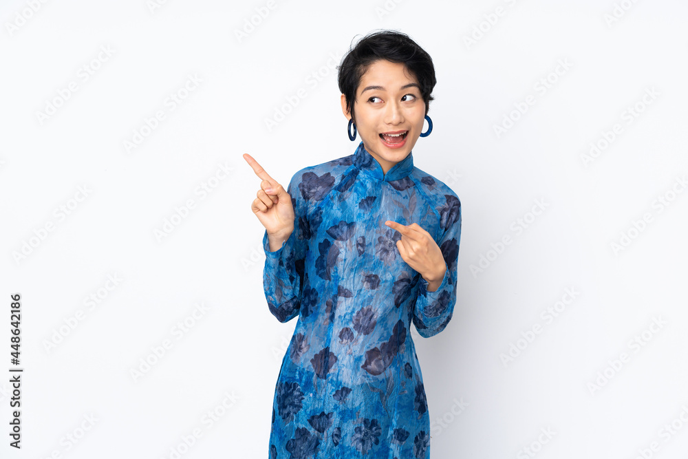 Young Vietnamese woman with short hair wearing a traditional dress over isolated white background intending to realizes the solution while lifting a finger up Young Vietnamese woman with short hair wearing a traditional dress over isolated white background intending to realizes the solution while lifting a finger up
