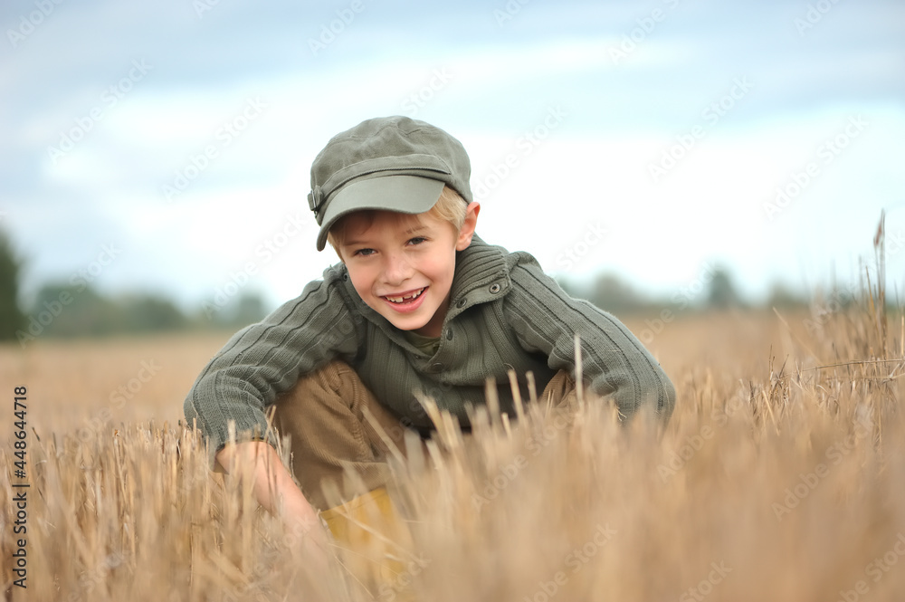 Happy little boy, smiling, crouching. Happy little boy, smiling, crouching.