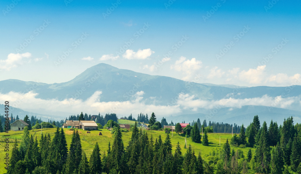 Summer mountainous rural landscape with a view of the village and the mountain Hoverla Carpathian Ukraine