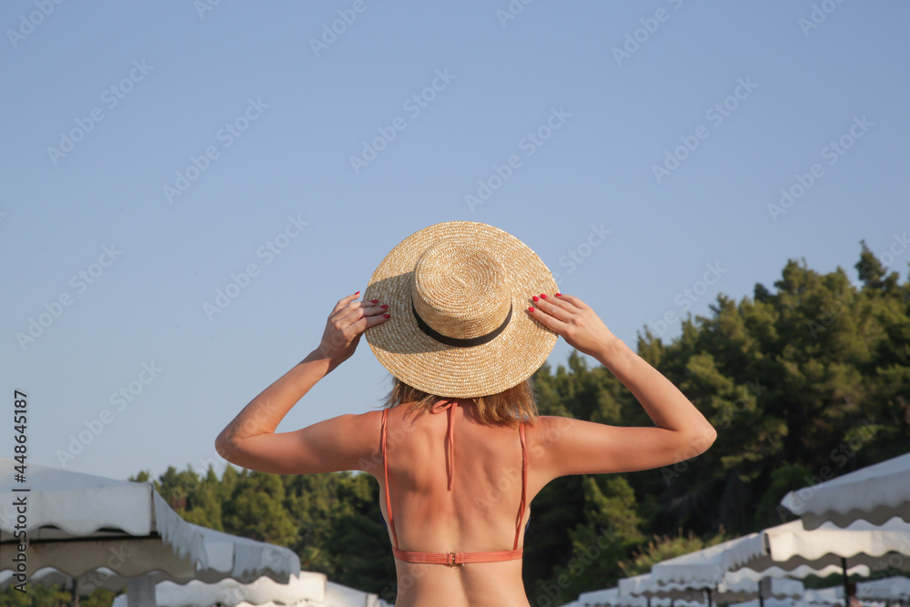 Tourist woman enjoying idyllic day at the beach.