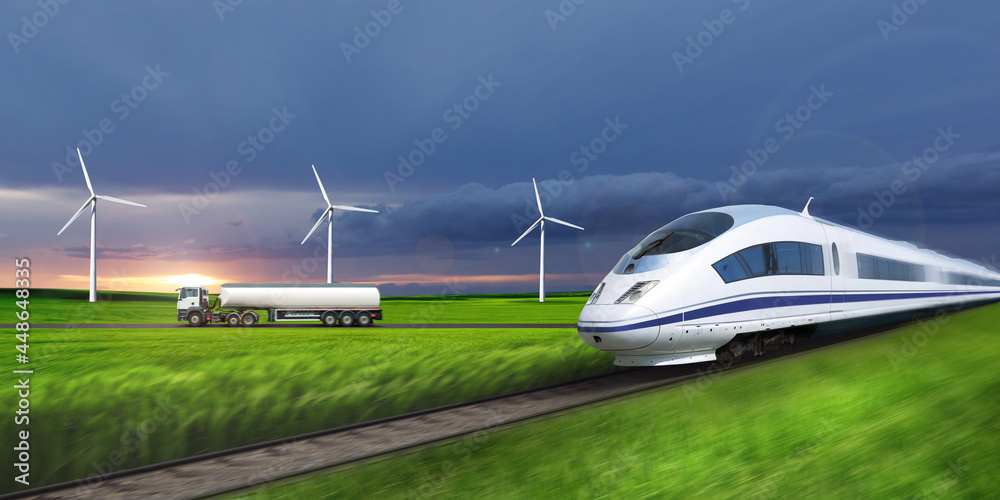 Fototapeta premium High speed train travels on a background of green fields.