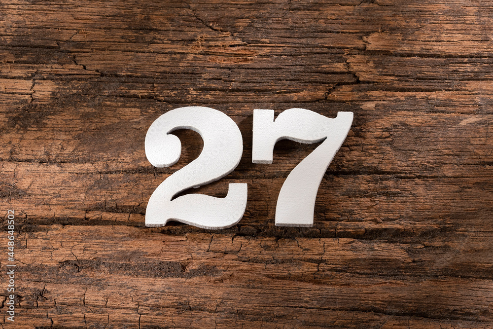 Number twenty seven 27 - White Piece on Rustic Wood Background