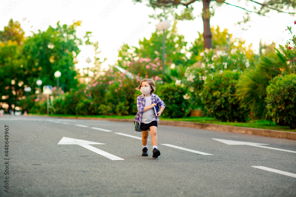 a beautiful little girl, a schoolgirl, is standing on the road, with a backpack, holding a diary in her hands a beautiful little girl, a schoolgirl, is standing on the road, with a backpack, holding a diary in her hands