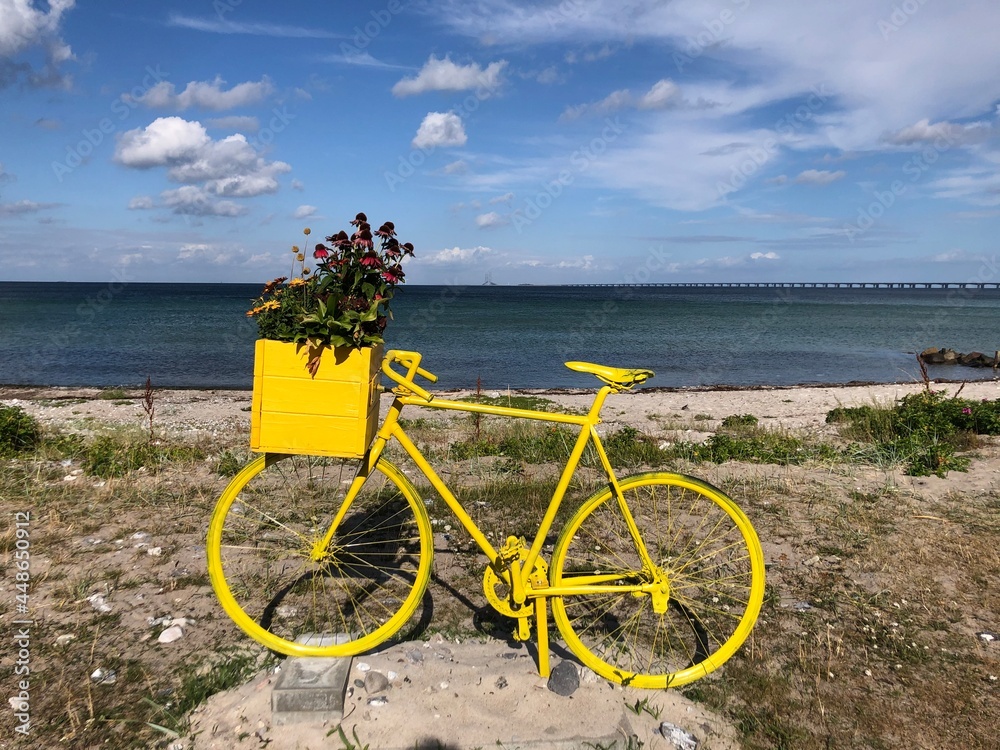 Fototapeta premium Old, decorative, yellow bike by the coast