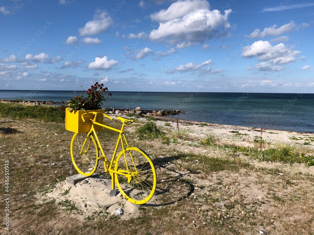 Fototapeta premium Old, yellow bike by the sea, Nyborg, Denmark