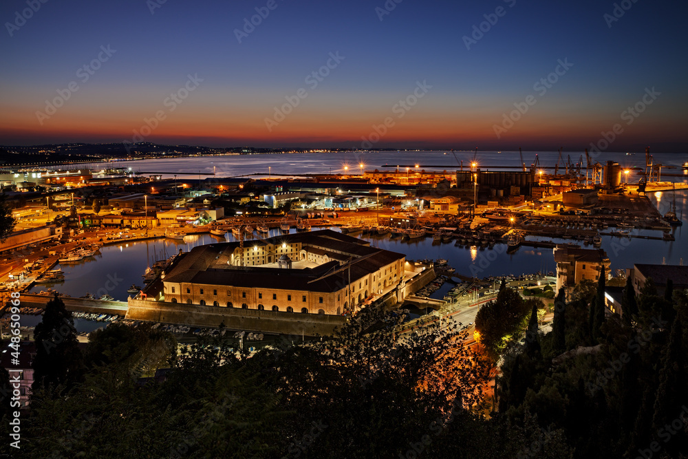 Ancona, Marche, Italy: night landscape of the port for the small boats and fishing vessels with the pentagonal Mole Vanvitelliana, built on 18th-century as a lazzaretto quarantine station