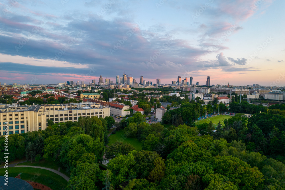 Obraz premium Warsaw at sunset. The capital of Poland is illuminated by a beautiful orange sun.