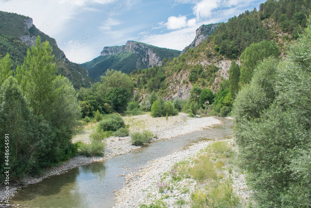 The photo shows a natural mountain landscape with a typical village in the north of Navarra, Spain.