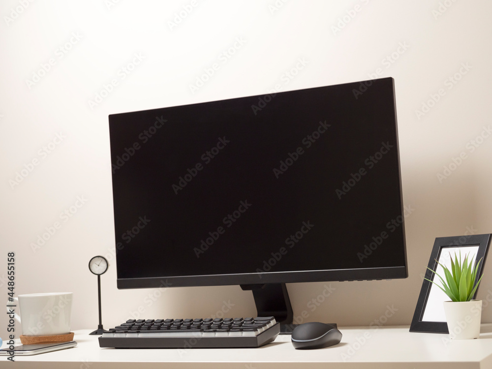 Computer with a wireless keyboard and a wireless mouse on a white table with a black clock a photo frame a mobile phone a white cup of coffee Computer with a wireless keyboard and a wireless mouse on a white table with a black clock a photo frame a mobile phone a white cup of coffee