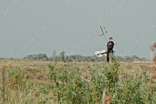 Kitesurfing, Kiteboarding action photos, man among waves quickly goes