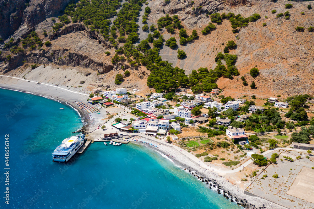 AGIA ROUMELI, CRETE, GREECE - JULY 20 2021: Aerial view of the village of Agia Roumeli at the exit of the Samaria Gorge on the Greek island of Crete.