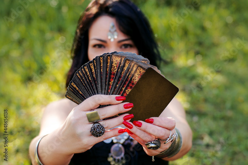 gypsy woman in the outdoors with cards of tarot