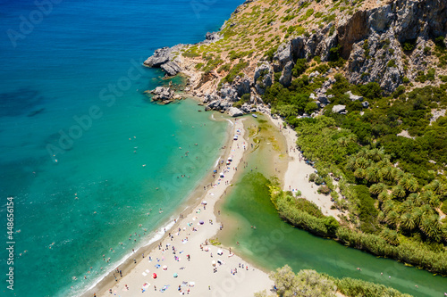 Aerial view of a beautiful palm tree forest leading to a sandy beach (Preveli, Crete)