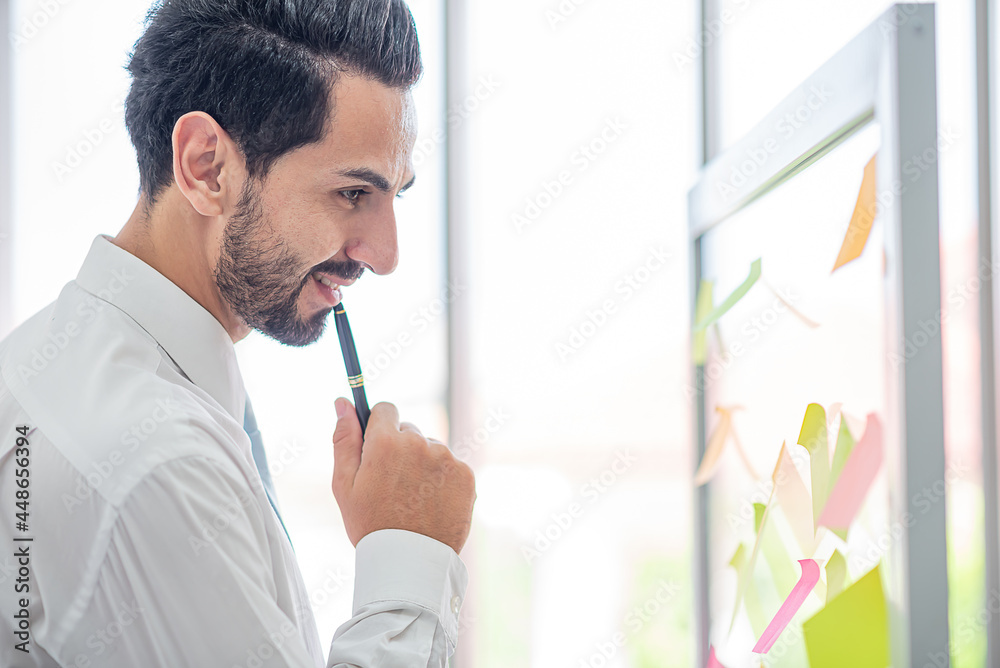 Fototapeta premium business man write pen to post it for idea analysis and planning marketing,goal to success