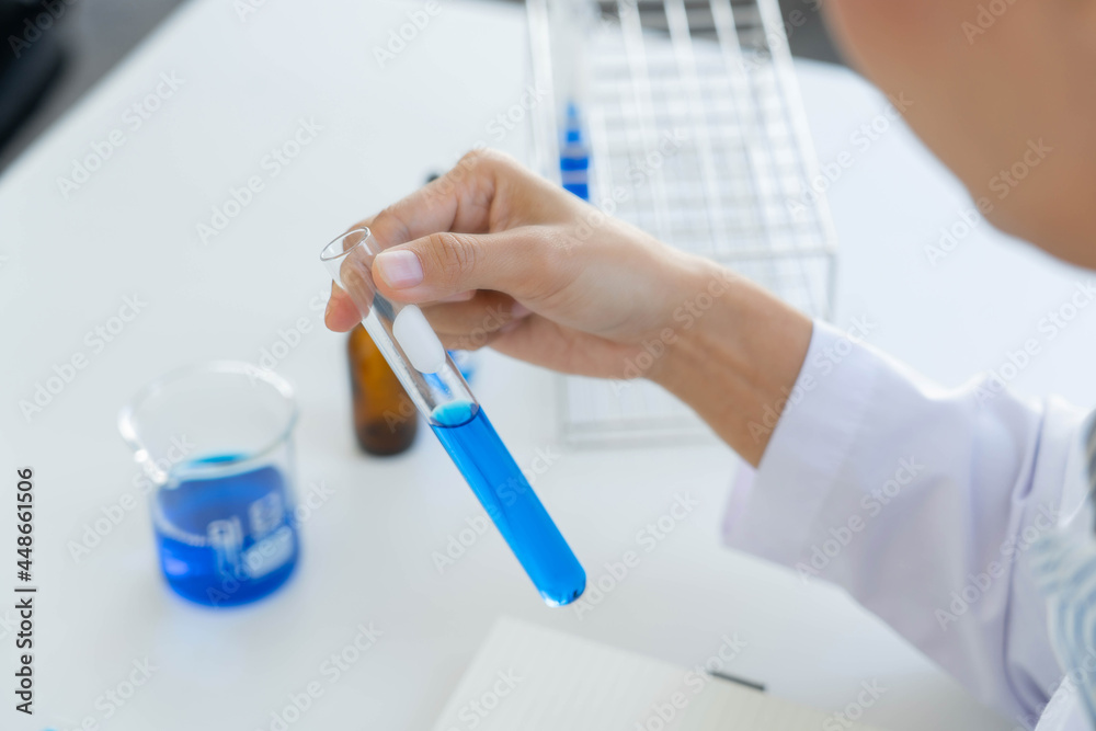 Scientist wear lab coat and protective wear are working with research or doing investigations with test tubes in experiment, Laboratory and development concept Scientist wear lab coat and protective wear are working with research or doing investigations with test tubes in experiment, Laboratory and development concept