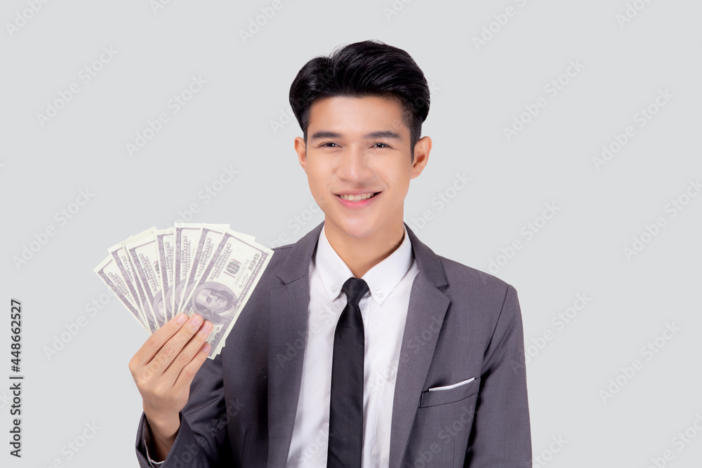 Young asian business man holding money dollar isolated on white background, businessman in suit holding banknote and success and excited with finance, savings and investment, income and spending. Young asian business man holding money dollar isolated on white background, businessman in suit holding banknote and success and excited with finance, savings and investment, income and spending.