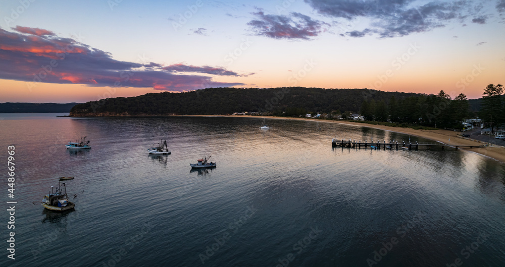 Fototapeta premium Sunrise panorama over the bay with boats and wharf