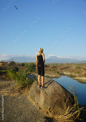 A woman taking picture around Bajulmati Dam in Banyuwangi Indonesia. photo