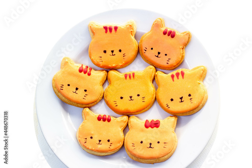 orange cat royal icing cookies on white plate