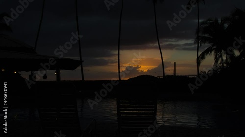 Sunset on the beach of Ricon, Puerto Rico. Timelapse view of a beautiful sunset with dense clouds sunset from the hotel. Beach - Chair and Palapa, Sunset Timelapse Video from Puerto Rico photo