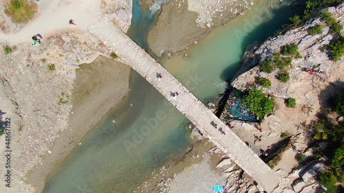 cenital drone view of the Ottoman Kadiut bridge and the Banjat e Benjës hot springs (sometimes referred to as Benja or Benje), which have become one of the most photogenic places in southern Albania. photo