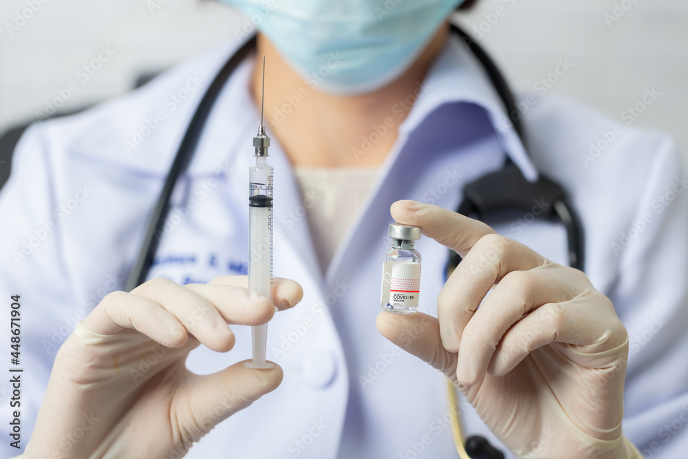 Nurse in mask hold syringe with vaccine. Covid-19, coronavirus disease, healthcare workers concept. Nurse in mask hold syringe with vaccine. Covid-19, coronavirus disease, healthcare workers concept.