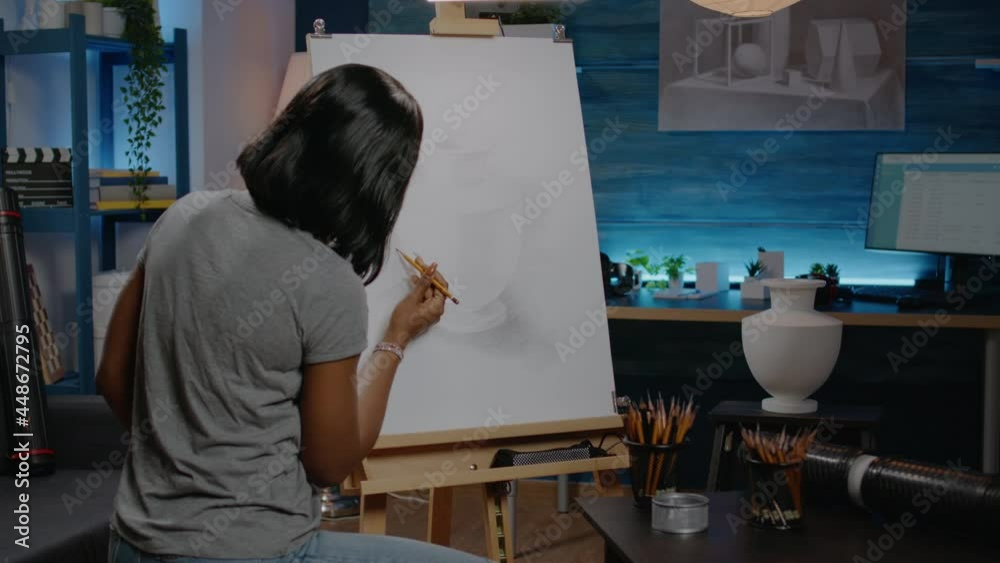 African american woman artist creating vase design using pencil and white canvas at workshop. Black young adult designing beautiful masterpiece and fine art for successful gallery African american woman artist creating vase design using pencil and white canvas at workshop. Black young adult designing beautiful masterpiece and fine art for successful gallery
