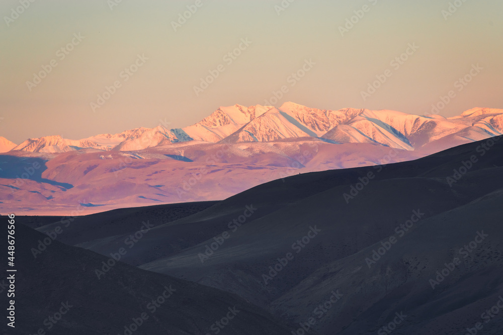 Snow-covered mountain peaks at sunrise. Autumn landscape of Kurai steppe in Altai, Siberia, Russia.
