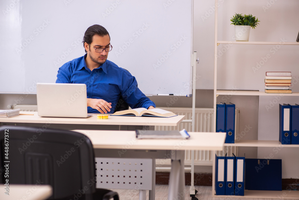 Young male teacher in front of whiteboard Young male teacher in front of whiteboard