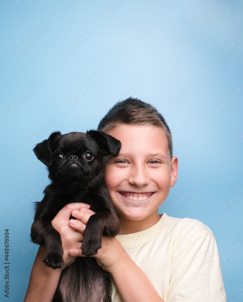 Boy smile with pet black dog puppy. Friends and happy concept Boy smile with pet black dog puppy. Friends and happy concept
