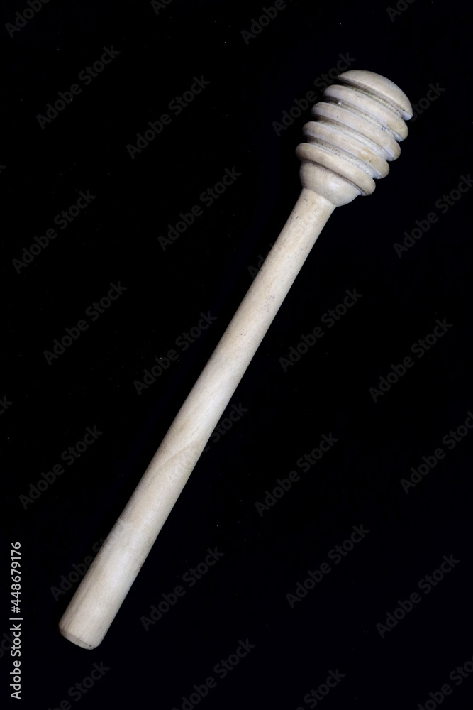 Full image of honey dipper in flat lay position on black background in HD size Full image of honey dipper in flat lay position on black background in HD size