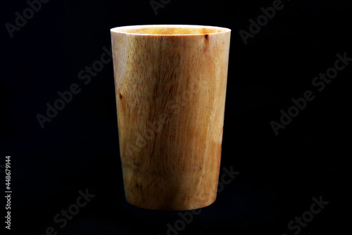 A manufactured wooden glass in black background in HD size