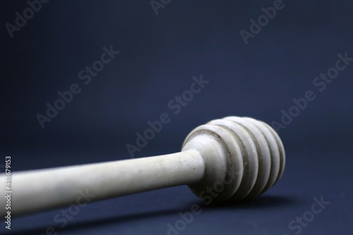 Close up of honey dipper lay in black background in HD size