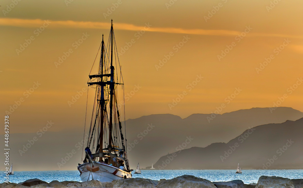 Pleasure sailboat near stone pier in the Red Sea near Eilat, Israel