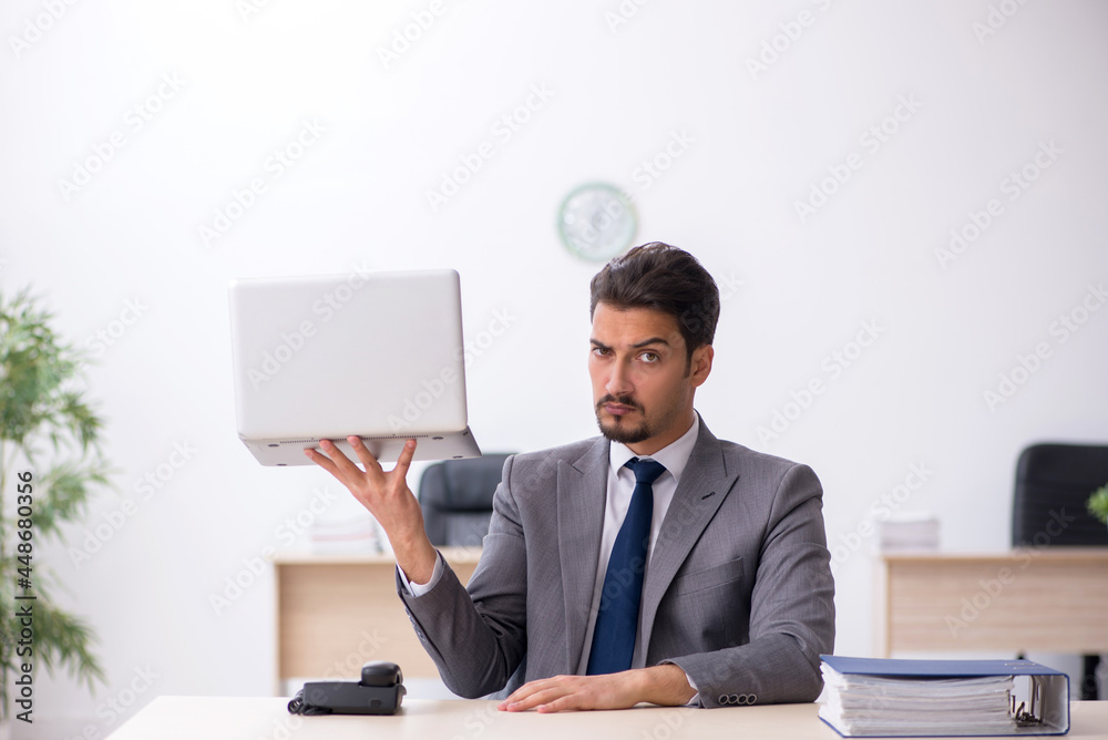 Young male employee working in the office Young male employee working in the office