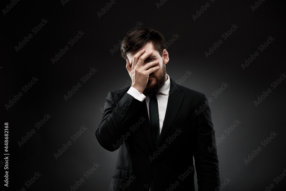 Tired businessman covering face with hand, hiding Tired businessman covering face with hand, hiding