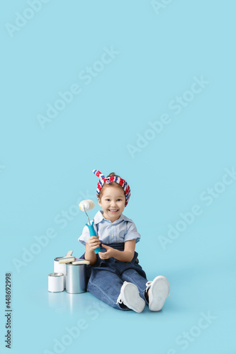 Little girl with paint roll...