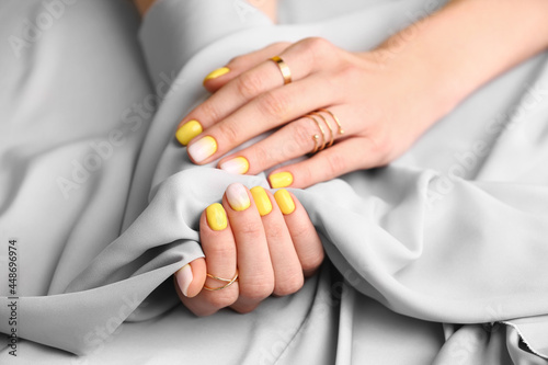 Female hands with beautiful manicure and fabric, closeup
