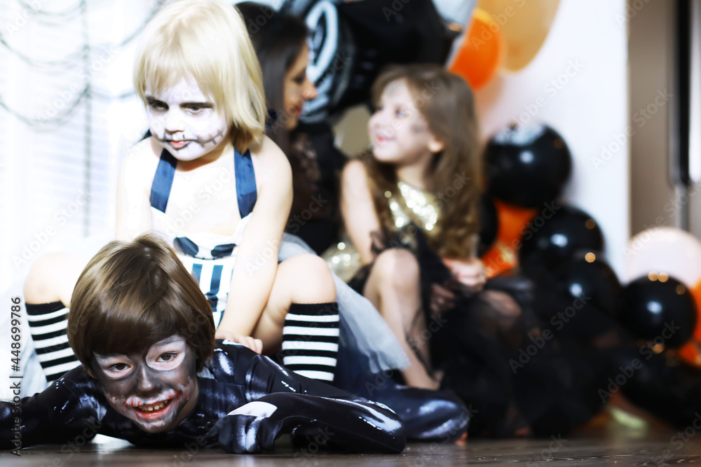 Fototapeta premium happy family with childrens in costumes and makeup on a celebration of Halloween