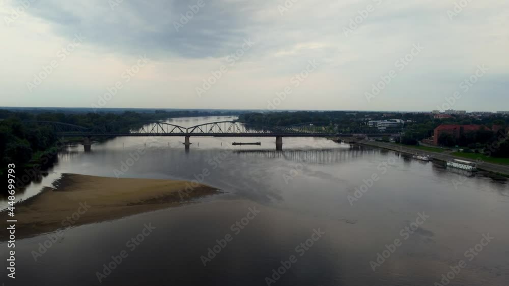 Aerial view on Vistula river with Jozef Pilsudski bridge in the early morning in Torun, Poland. Aerial view on Vistula river with Jozef Pilsudski bridge in the early morning in Torun, Poland.