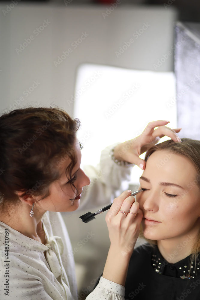 Young girl with a make-up artist Young girl with a make-up artist