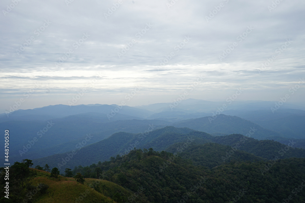 Natural landscape of green mountain range with cloudy blue sky