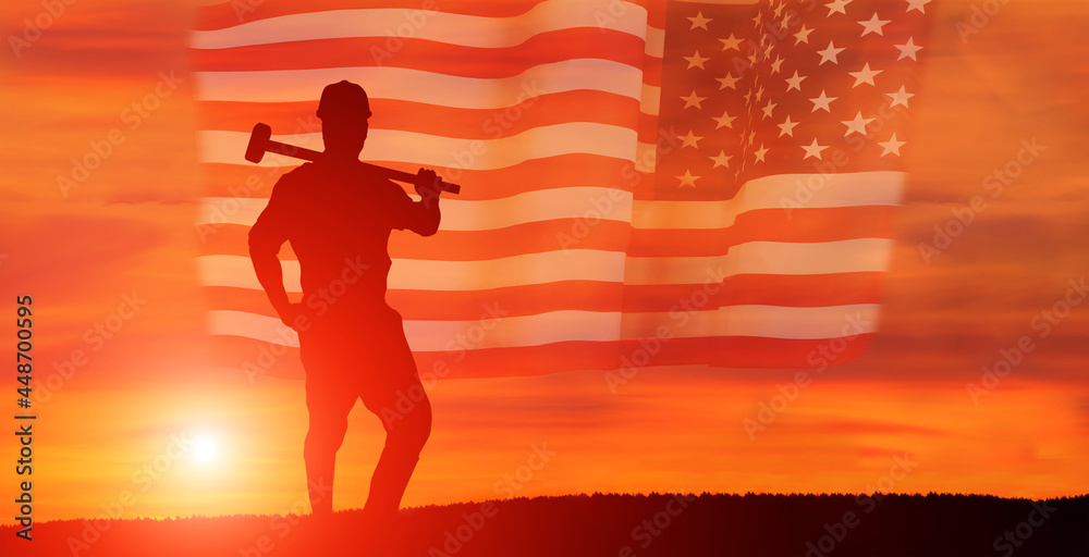 Worker on the USA flag background . Labor day holiday concept.