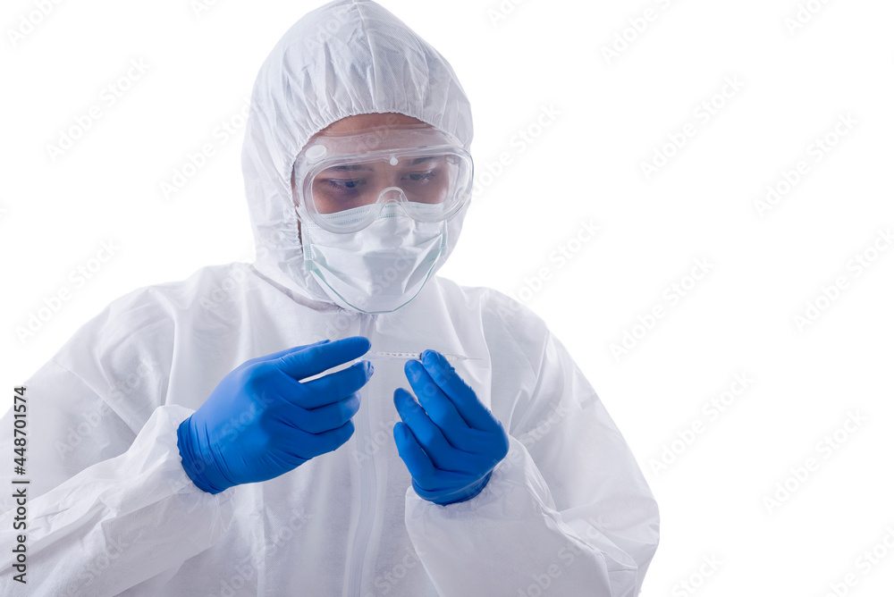 Health worker man with a protective suit and gloves holding syringe Health worker man with a protective suit and gloves holding syringe