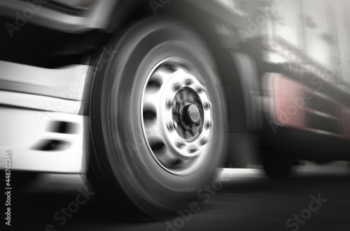 Front of Cargo Truck Wheels Spininng, Speed Motion Blur Driving on The Road. Industry Road Freight by Truck. Logistic and CargoTransport Concept. 